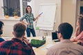 Young pretty woman making presentation and training near whiteboard for colleagues Royalty Free Stock Photo