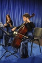 Young pretty women violinist and cellist playing music during concert. Kyiv ,Ukraine