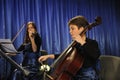 Young pretty women violinist and cellist playing music during concert. Kyiv ,Ukraine