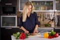 Young pretty young woman cooking salad in kitchen Royalty Free Stock Photo