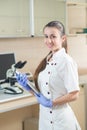 Young prettyl woman scientist holding a folder Royalty Free Stock Photo