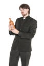 Young priest with bottle of alcohol isolated Royalty Free Stock Photo