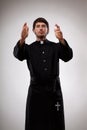 Young priest is gesturing to believers Royalty Free Stock Photo