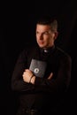 Young priest holding and crypto bible with bitcoin Royalty Free Stock Photo