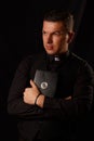 Young priest holding and crypto bible with bitcoin Royalty Free Stock Photo