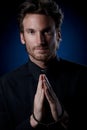 Young priest praying to God Royalty Free Stock Photo