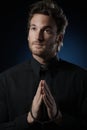 Young priest praying to God Royalty Free Stock Photo