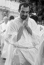 A young priest prays during the Corpus Christ procession