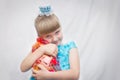 The young Princess in the blue dress pressed to his chest Novogodniy gift bags of candy.Portrait of a child.