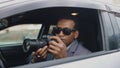 Private detective man sitting inside car and photographing with dslr camera Royalty Free Stock Photo