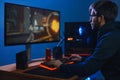 Young pro gamer playing online video game in his room Royalty Free Stock Photo