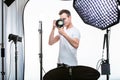 Young pro photographer with digital camera Royalty Free Stock Photo