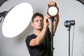 Young, pro photographer setting lights in his studio Royalty Free Stock Photo