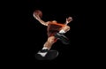 Young professional basketball player in action, motion isolated on black background, look from the bottom. Concept of Royalty Free Stock Photo