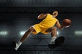 Young professional basketball player in action, motion isolated on black background, look from the bottom. Concept of Royalty Free Stock Photo