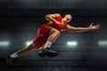 Young professional basketball player in action, motion isolated on black background, look from the bottom. Concept of Royalty Free Stock Photo