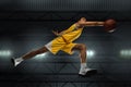 Young professional basketball player in action, motion isolated on black background, look from the bottom. Concept of Royalty Free Stock Photo