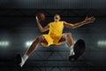 Young professional basketball player in action, motion isolated on black background, look from the bottom. Concept of Royalty Free Stock Photo