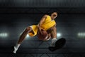 Young professional basketball player in action, motion isolated on black background, look from the bottom. Concept of Royalty Free Stock Photo