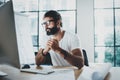 Young professional bearded designer wearing eye glasses working at modern loft studio-office with desktop computer Royalty Free Stock Photo