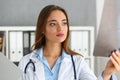 Young professional beautiful female doctor examining x-ray of patient Royalty Free Stock Photo
