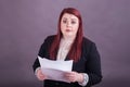 Young professional business woman holding stack of papers