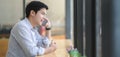 Young professional businessman speaking on the phone with his customer in modern office Royalty Free Stock Photo