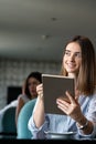 Young professional businesswoman sitting at table at cafe Royalty Free Stock Photo