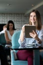 Young professional businesswoman sitting at table at cafe Royalty Free Stock Photo