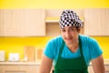 The young professional cook preparing in kitchen Royalty Free Stock Photo