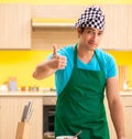 Young professional cook preparing in kitchen Royalty Free Stock Photo
