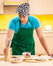 Young professional cook preparing in kitchen Royalty Free Stock Photo