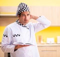 Young professional cook preparing in kitchen Royalty Free Stock Photo