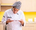 Young professional cook preparing in kitchen Royalty Free Stock Photo