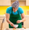 Young professional cook preparing in kitchen Royalty Free Stock Photo