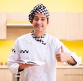 Young professional cook preparing in kitchen Royalty Free Stock Photo