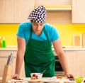 Young professional cook preparing in kitchen Royalty Free Stock Photo