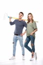 Young professional couple holding paint roller isolated on white