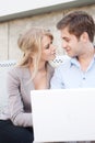 Young professional couple using laptop