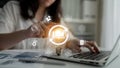 Young Professional Engaged in Machine Learning Model Development with Illuminated Light Bulb and Digital Interface Royalty Free Stock Photo