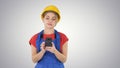 Young Professional Female Contractor Wearing Hard Hat Texting wi