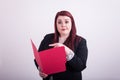 Young professional female holding an open a red file folder pointing at it