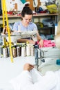 young professional female tailor using sewing machine Royalty Free Stock Photo