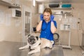 Young professional female veterinarian doctor hold pug dog before exam in veterinary clinic Royalty Free Stock Photo