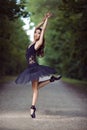 Ballet Concepts and Ideas. Young Professional Japanese Female Ballet Dancer in Black Tutu Demonstrating Ballet Pas in Summer