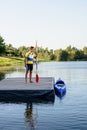 Young Professional Kayaker Getting Ready for Morning Kayak Training on River. Sport and Active Lifestyle Concept