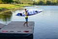 Young Professional Kayaker Getting Ready for Morning Kayak Training on River. Sport and Active Lifestyle Concept