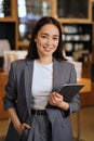 Young professional leader Asian business woman wearing suit, vertical portrait. Royalty Free Stock Photo