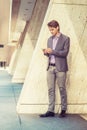 Young Professional Man texting on cell phone outside in New York City Royalty Free Stock Photo