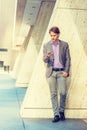 Young Professional Man texting on cell phone outside in New York City Royalty Free Stock Photo